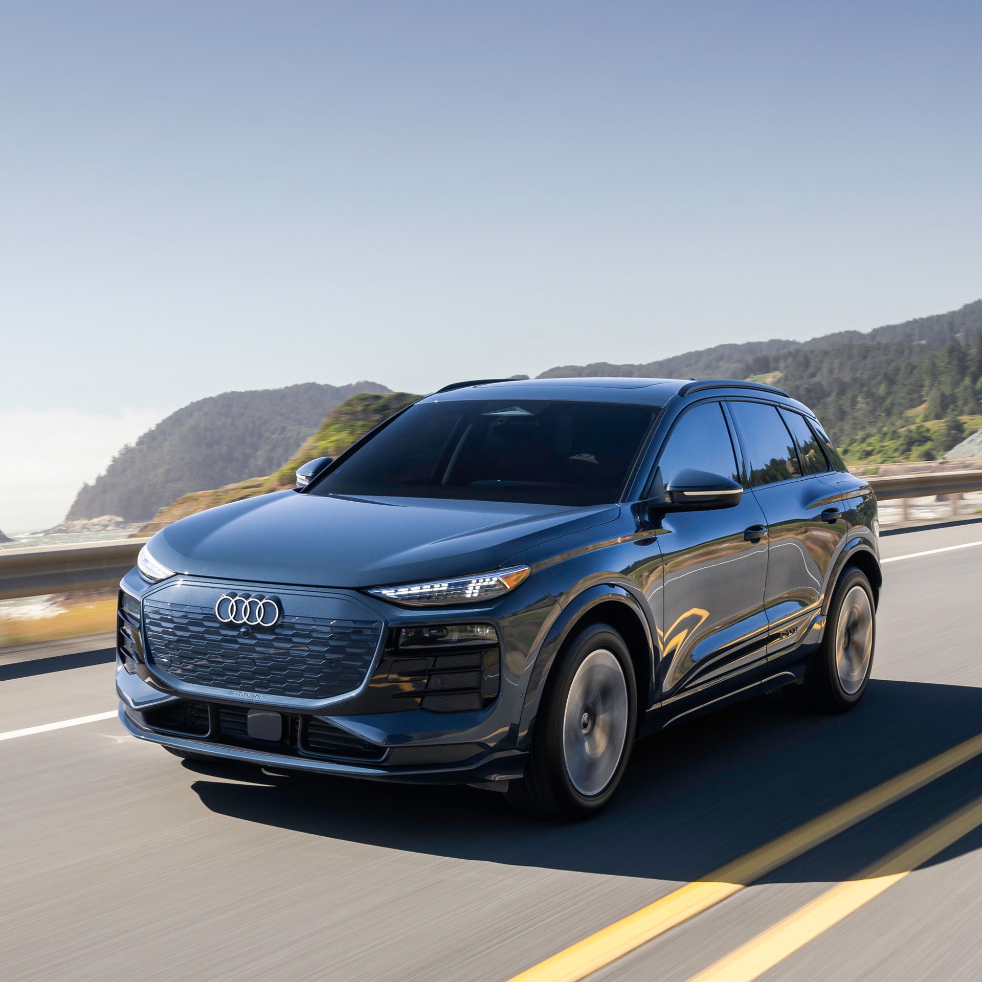 Right profile view of an Audi Q6 etron accelerating.